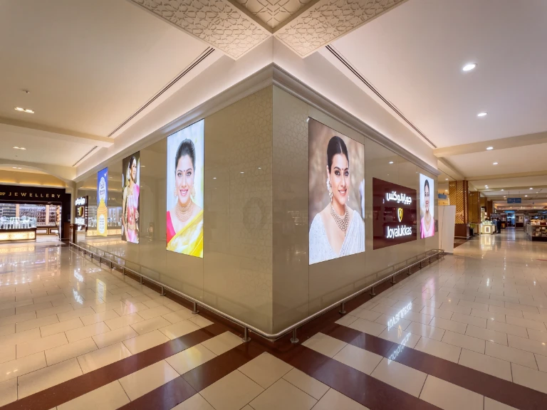 Joyalukkas corner fabric lightboxes in premium shopping mall corridor